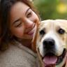 Dog owners smiling with content dog